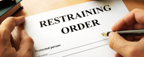 A restraining order document being signed and filed by an attorney
