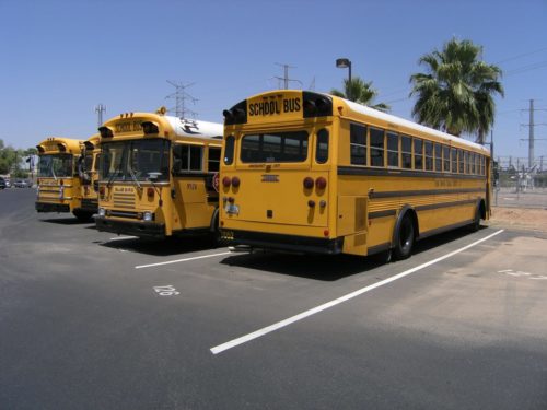 Parked school buses respecting back to school rules of the road