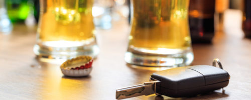 Glasses of beer next to a car key to show high DUI rates in FL
