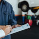 Signing paperwork at a mechanic - sue mechanic