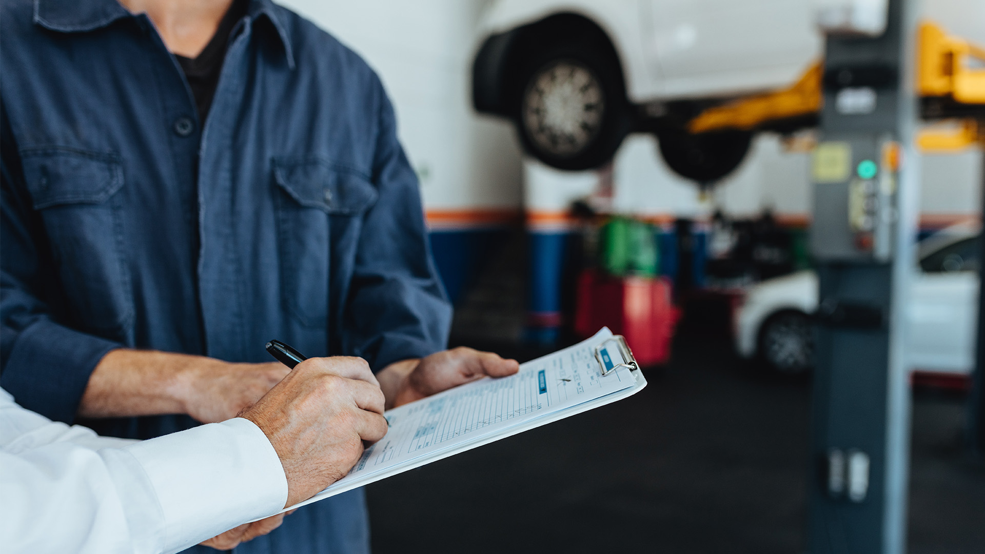 Signing paperwork at a mechanic - sue mechanic