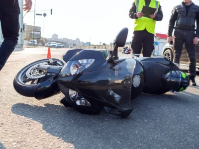 black motorcycle on its side on the road