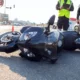 black motorcycle on its side on the road
