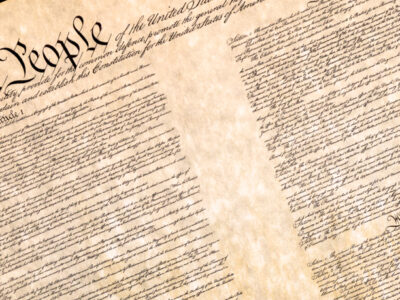 An image of upper-left corner or the U.S. Constitution's preamble, including the words, "We the People."