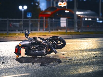 Motorcycle lying on the roadway at night.