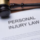 A gavel on a sheet of paper that has a heading of "personal injury law."